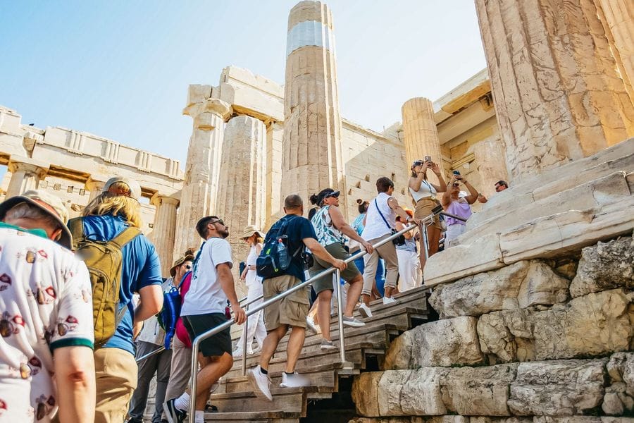 Visitors with Acropolis tickets climbing the stairs through the Propylaea entrance