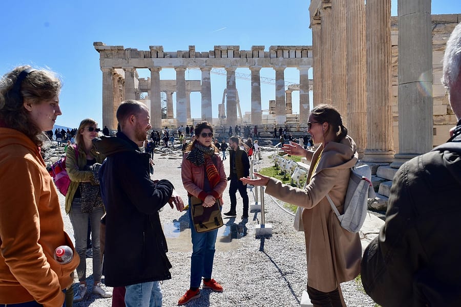 Tour leader talking to her Acropolis tour group in front of the Parthenon in Athens